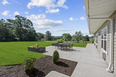 Outdoor patio area with seating and green lawn