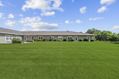 Spacious outdoor area with well-maintained grass and gardens