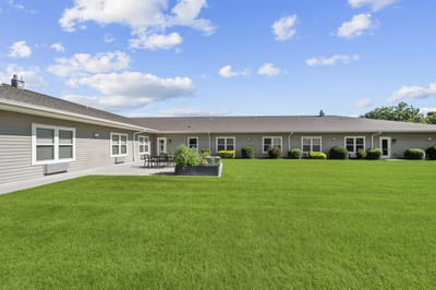 Outdoor area with green lawn and building