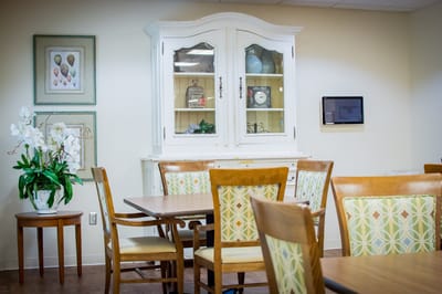 Cozy common area with dining tables and cabinet