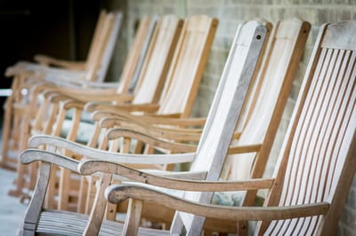Row of wooden rocking chairs on a porch