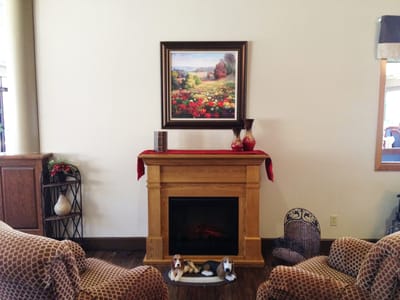 Cozy common area with a fireplace and decorative painting