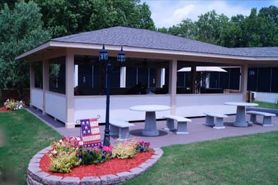 Outdoor seating area with tables and garden flowers