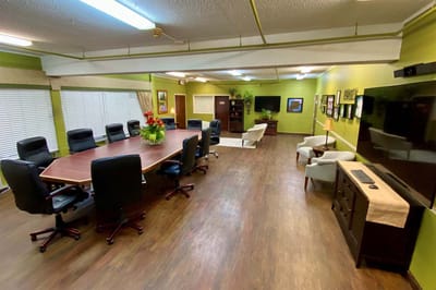 Bright common area with a large meeting table