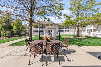 Outdoor seating area with tables near the building
