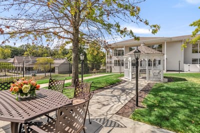 Outdoor seating area with gazebo and landscaped gardens