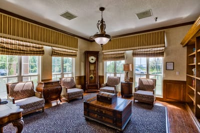 Interior view of a cozy lounge area with seating and a clock