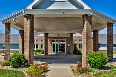 Entrance of Pine Grove Manor with a covered walkway