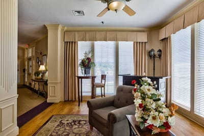 Cozy common area with comfortable seating and floral arrangement