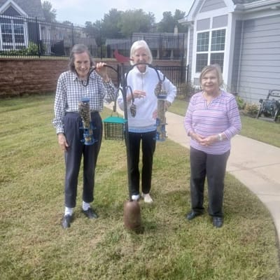 Residents participating in outdoor activity with bird feeders