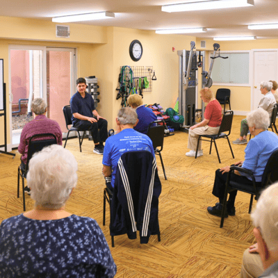Residents participating in a seated exercise class