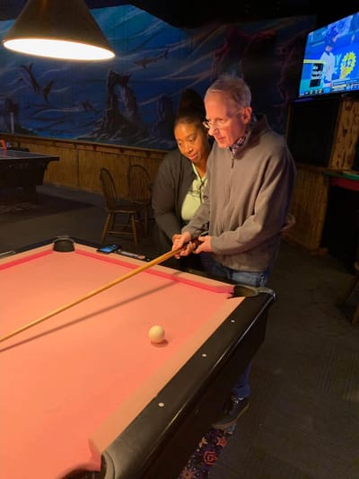 Residents enjoying a game of billiards in a common area