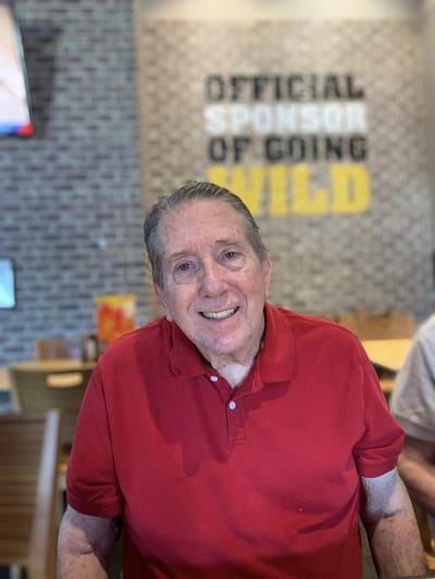 Senior resident smiling in a bright indoor setting