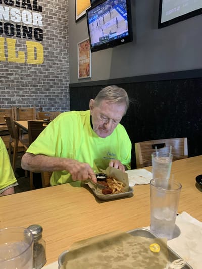 Resident enjoying a meal in a dining area