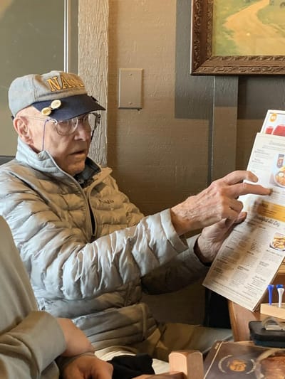 Resident reviewing a menu in a dining setting