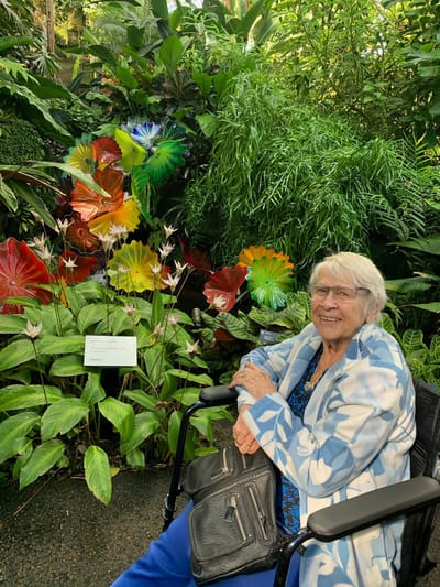 Resident enjoying the garden with vibrant flowers