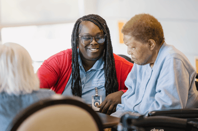 Staff member engaging with a resident in a common area