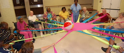 Residents participating in a group activity with elastic bands