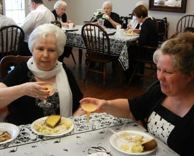 Two residents enjoying a meal in a dining room