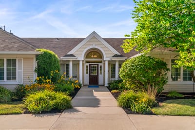 Front entrance of a residential care facility with flowers