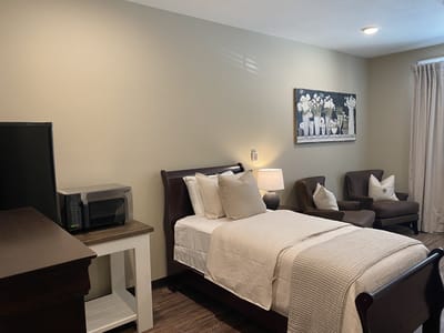 Cozy resident room with a bed and seating area
