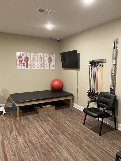 Physical therapy room with equipment and charts