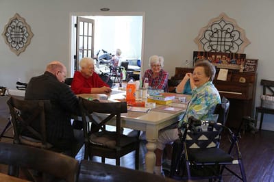 Residents engaged in a social activity around a table