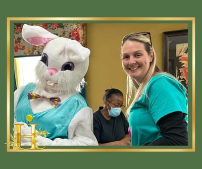 Staff member celebrating with a resident dressed as the Easter Bunny