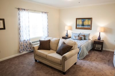 Cozy resident room with a sofa and bed