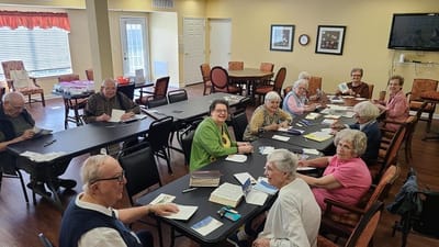 Residents engaged in a creative activity inside the facility