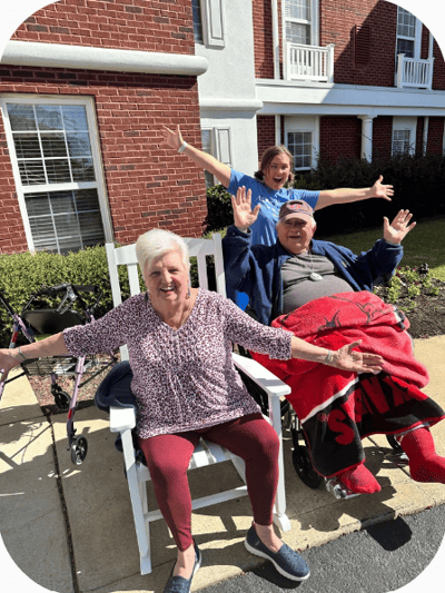 Residents enjoying time outside with staff member