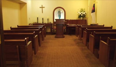 Interior of a chapel space with pews and altar