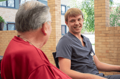 Two residents conversing in an outdoor area
