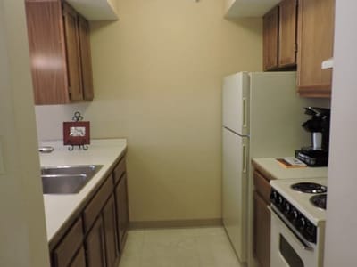 Kitchen area with appliances and cabinets