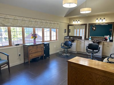 Interior of a hair salon space with styling chairs and natural light