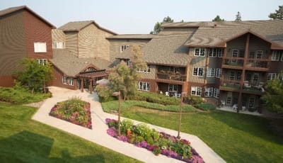 Aerial view of a senior living facility with gardens and pathways