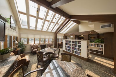 Bright common area with natural light and bookshelves
