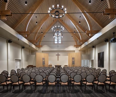 Interior view of a multi-purpose room with a cross