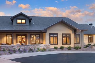 Exterior view of a senior living facility with landscaping
