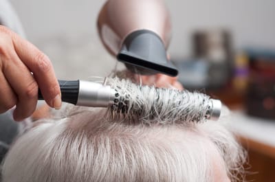 Stylist doing hair in a salon setting