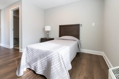 Private resident room with a bed and lamp