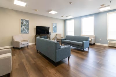 Bright common area with seating and television