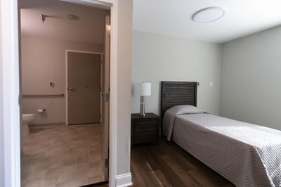 A private resident room with a bed and bathroom