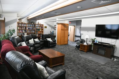 Cozy common area with seating and bookshelves