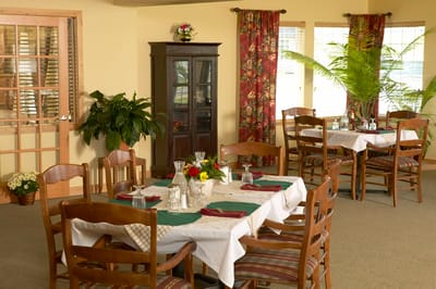 Cozy dining room set for a meal with floral decor