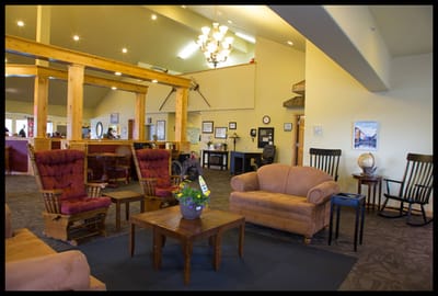 Bright common area with seating and a chandelier