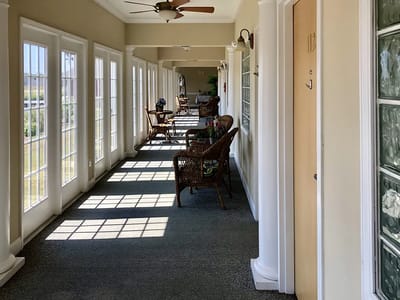 Hallway with large windows and seating areas
