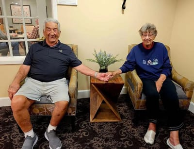 Two residents sitting together in a common area