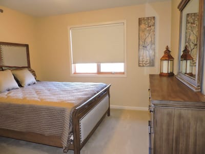 Cozy interior of a resident's room with a bed and dresser