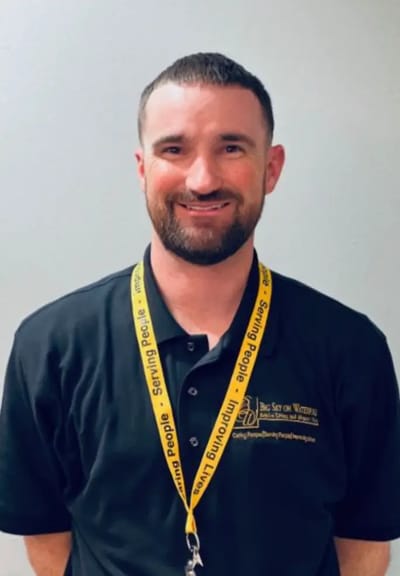 Staff member wearing a branded facility polo shirt